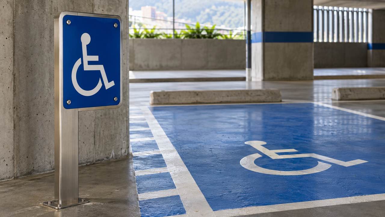 Vertical accessibility sign beside a space marked on the floor